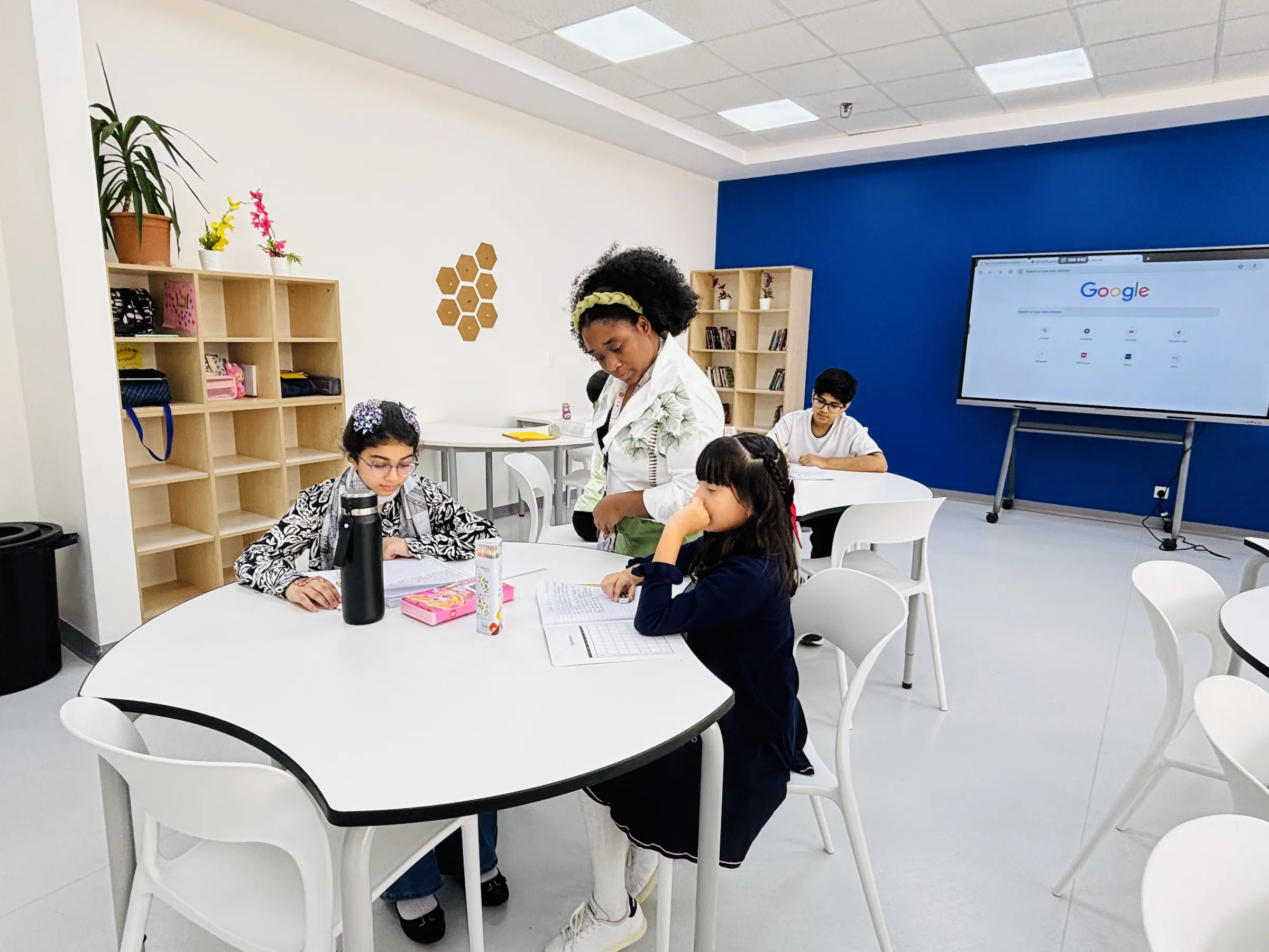 Elementary students engaged in a lesson in a modern AISY classroom