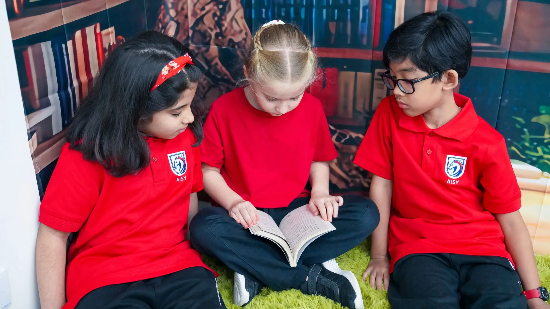 Young learners reading a book together