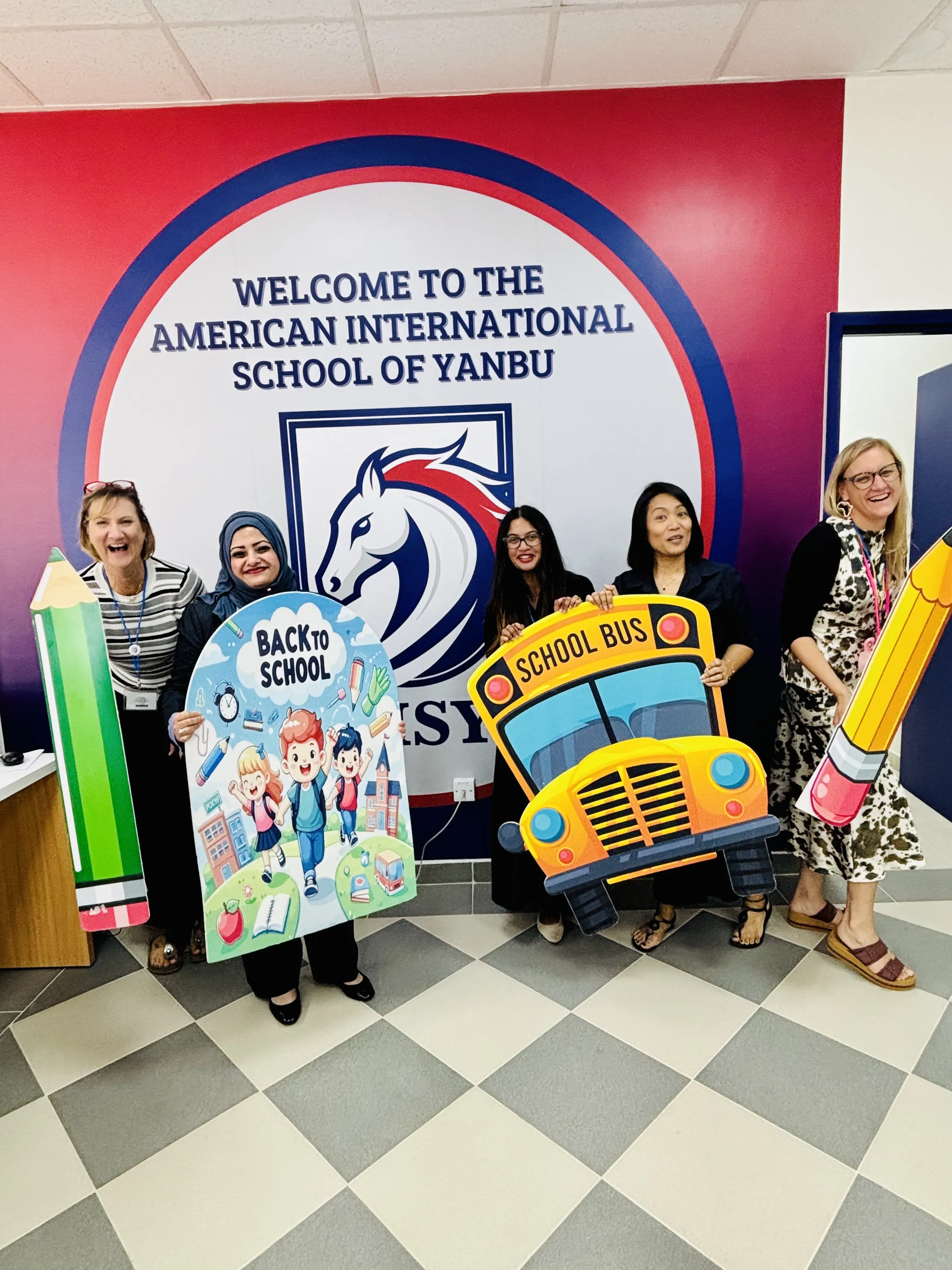 AISY staff welcoming scholars back to school at the reception entrance