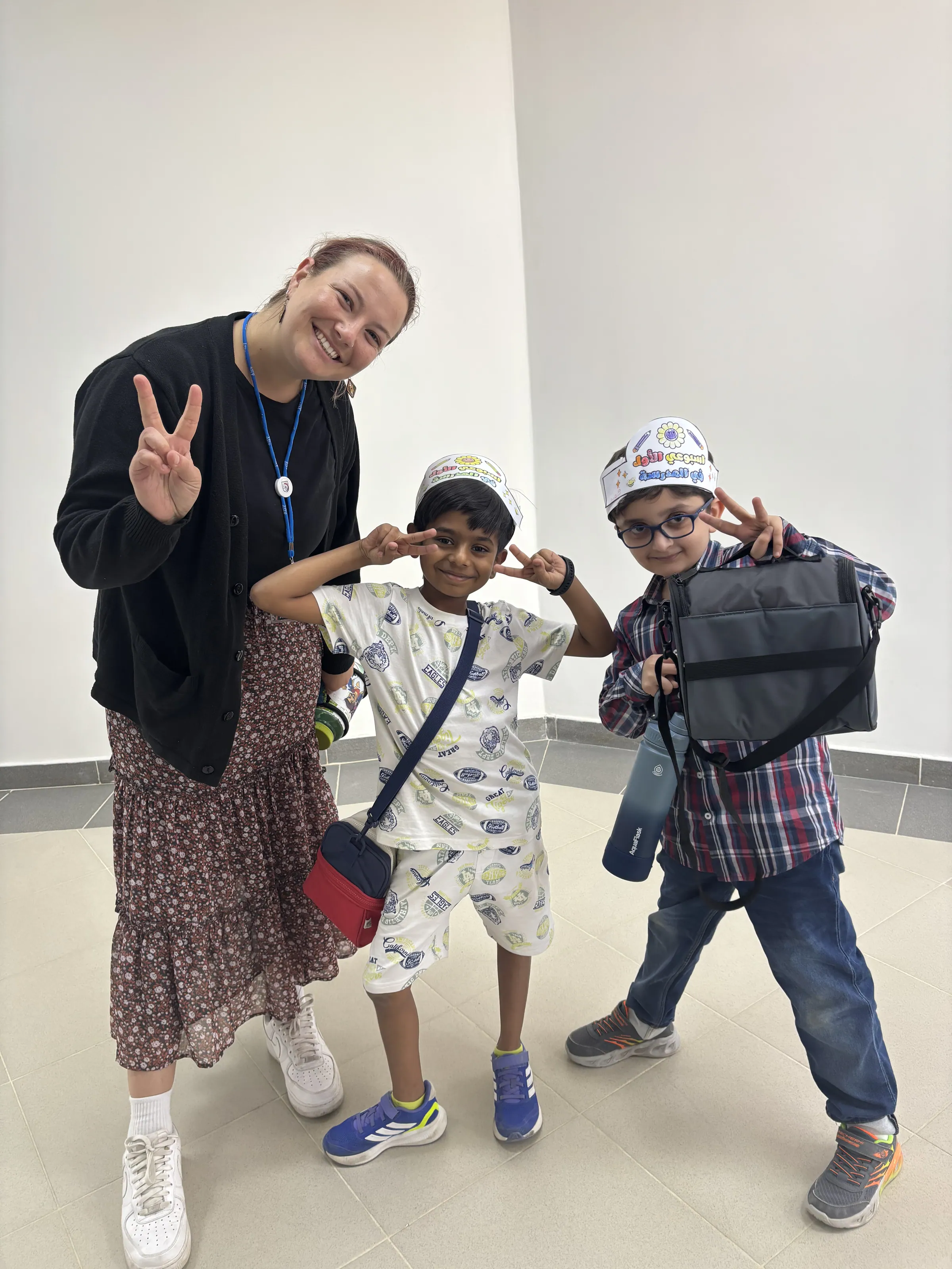 An AISY teacher and two scholars sharing a happy moment between classes